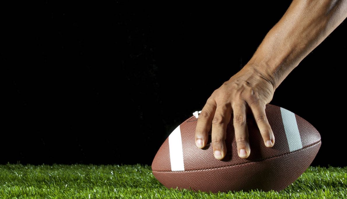 Hand holding onto football