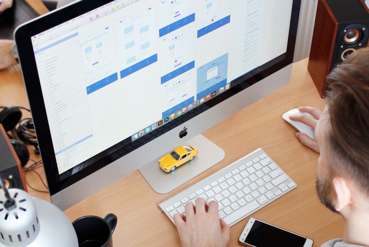 Man sitting in front of laptop looking at wireframes